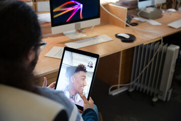 Young man using tablet computer at desk