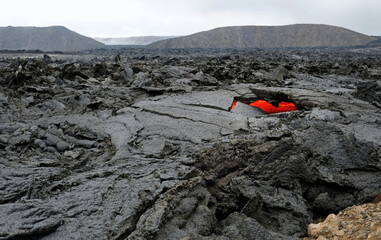 Glimpses of lava through a heart-shaped opening near Iceland's newest volcano, Geldingadalir