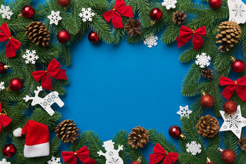 Fototapeta na wymiar Christmas background with fir branches and Christmas decor. Top view, copy space for text