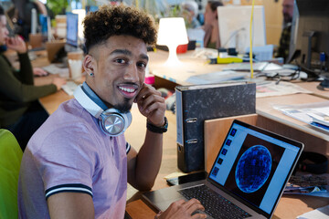 Young man working at laptop computer