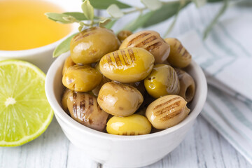 Grilled green olives. Tasty organic green olives in the plate.