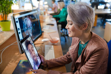 Young woman using tablet computer at desk