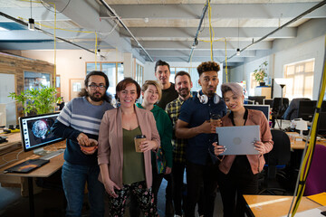 Team posing in office, smiling