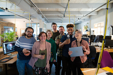 Team posing in office, smiling