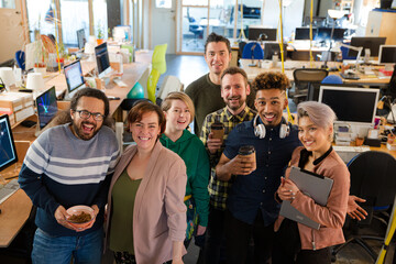 Team posing in office, smiling