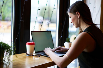 Skilled copywriter doing distance job for creating text ideas typing publication on modern laptop...