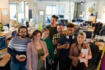 Team posing in office, smiling