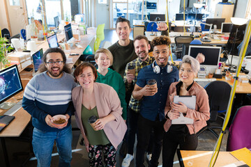 Team posing in office, smiling