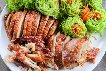 Roasted duck with green noodles.
