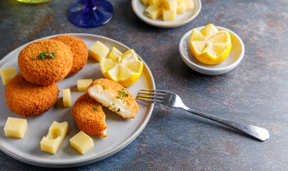 Homemade cheese croquettes. A delicious starter homemade cheese croquettes with a piece of lemon on the side.
