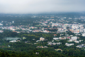 view in the mountains with road cityscape over the city building hotel, shopping mall,temple and houses air atmosphere rain fog sky abstract with white clouds.