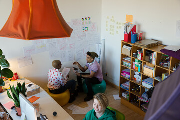 Man and woman discussing work in cosy office