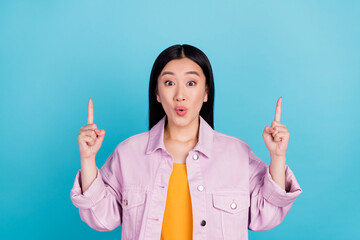 Portrait of attractive amazed cheerful girl pointing up copy space ad pout lips isolated over...