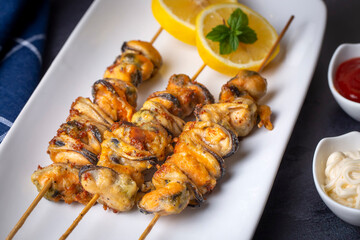 Fried mussels, delicious skewered mussels (Turkish name; midye tava, cöp sis midye)