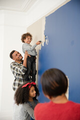 Happy family painting wall