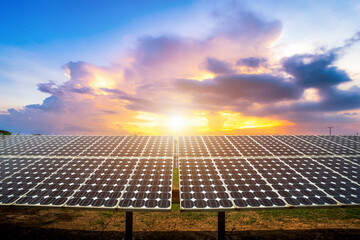 Photovoltaic modules solar power plant on dramatic sunset sky background,clean Alternative power energy concept.