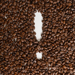 Roasted grains of black coffee forming an exclamation mark.
