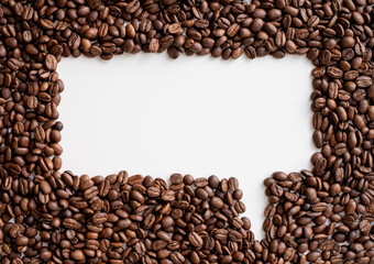Group of roasted grains of black coffee beans forming a message icon shape on white background. Free space for your text