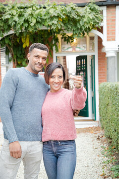 Portrait happy couple with keys to new house