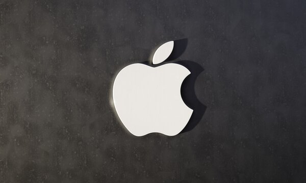 Three-dimensional Apple logo against dark textured background. Editorial 3D illustration