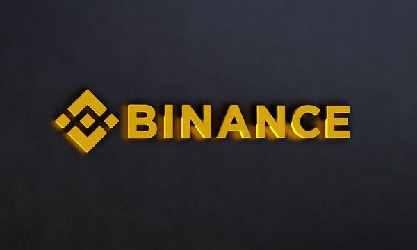 Three-dimensional Binance logo against dark wall. Binance is a leading cryptocurrency exchange founded in 2017. Editorial 3D illustration