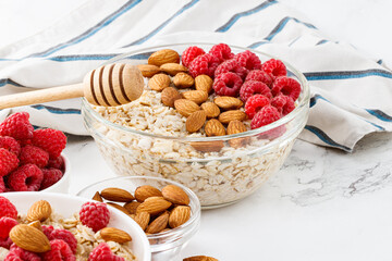 Healthy breakfast. Bowl with oatmeal with fresh raspberries and almonds