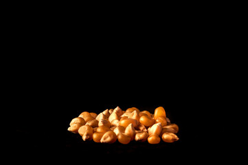 Corn grouped on black background. side view. Concept colors and contrasts. Still life darkfood.