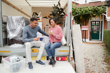 Couple talking at back of moving van