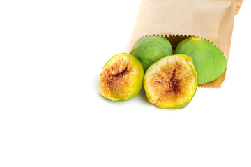 fresh ripe figs in paper bag isolated on white background. 