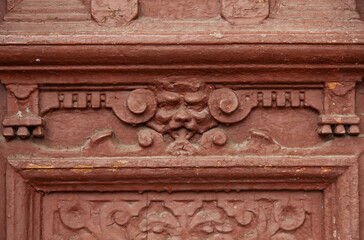 mascaron, decorative element of old wooden doors