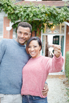 Portrait couple with keys to new house