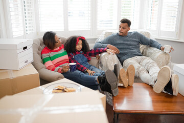 Fototapeta premium Family taking a break from moving, relaxing in living room