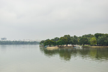 Flying Indian Flag at Water lake and Green Trees Blue Sky Landscape 
