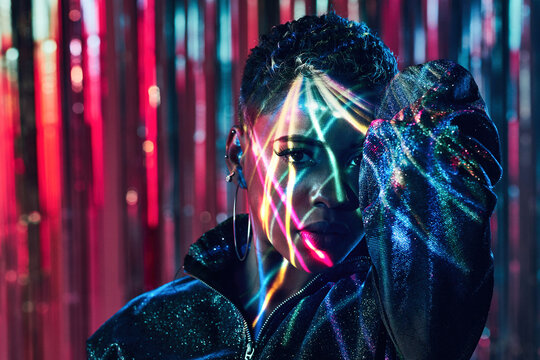 Cool black model in ultraviolet light dancing in nightclub