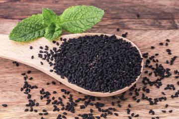 Thyme black seeds on wooden background, close up. Organic food