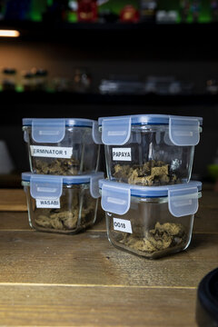 Dry cannabis buds in containers with titles