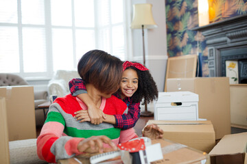 Mother and child hugging in living room