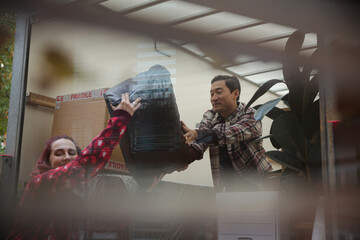 Friends moving, unloading moving van