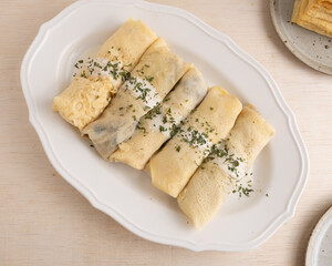 savoury stuffed mushroom spinach crepe on oval plate