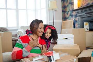 Mother and child hugging in living room