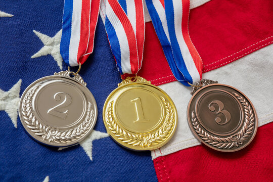 Gold, silver and bronze medals set on USA flag background. Sports athletes winners prize - Powered by Adobe