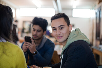 Young adults using smart phones at table