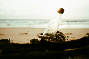 Plastic water bottles pollution on beach sunset.Empty used dirty plastic bottles.