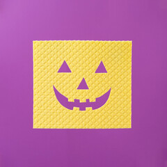 Yellow sponge with happy pumpkin face for Halloween cleaning household idea. Modern.