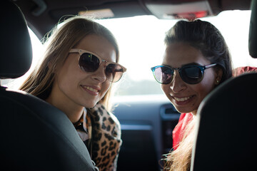 Portrait happy, playful young women wearing sunglasses in car
