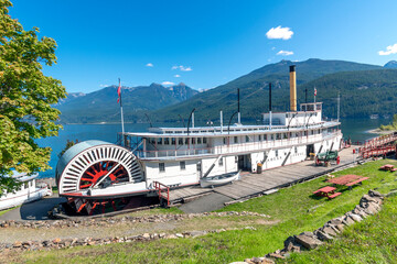 A vintage paddle steamer sternwheeler sits in the bay at Kootenay Lake at the Moyie Sternwheeler National Historic Site in the village of Kaslo.