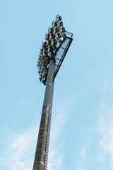 Pole with spotlights at a sports stadium.