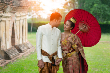 Thai couple wear Thai traditional wedding dress at ancient place. wedding ceremony, asian thai ceremony, thailand culture and romantic couples concept.