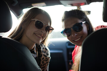 Portrait happy, playful young women wearing sunglasses in car