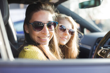 Portrait happy, playful young women wearing sunglasses in car